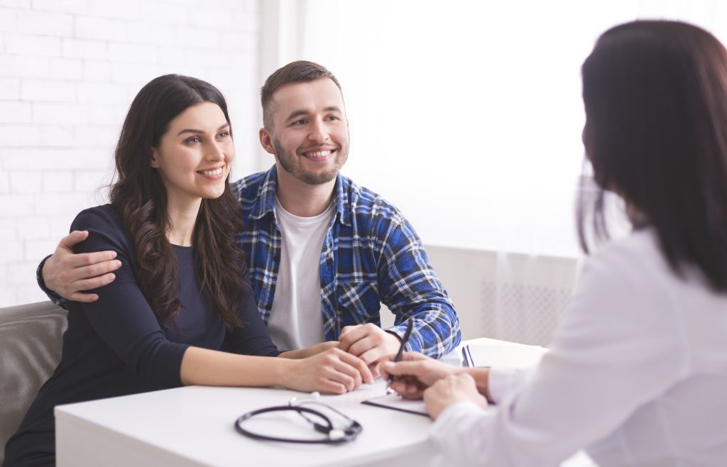 Young couple at doctor's appointment at clinic