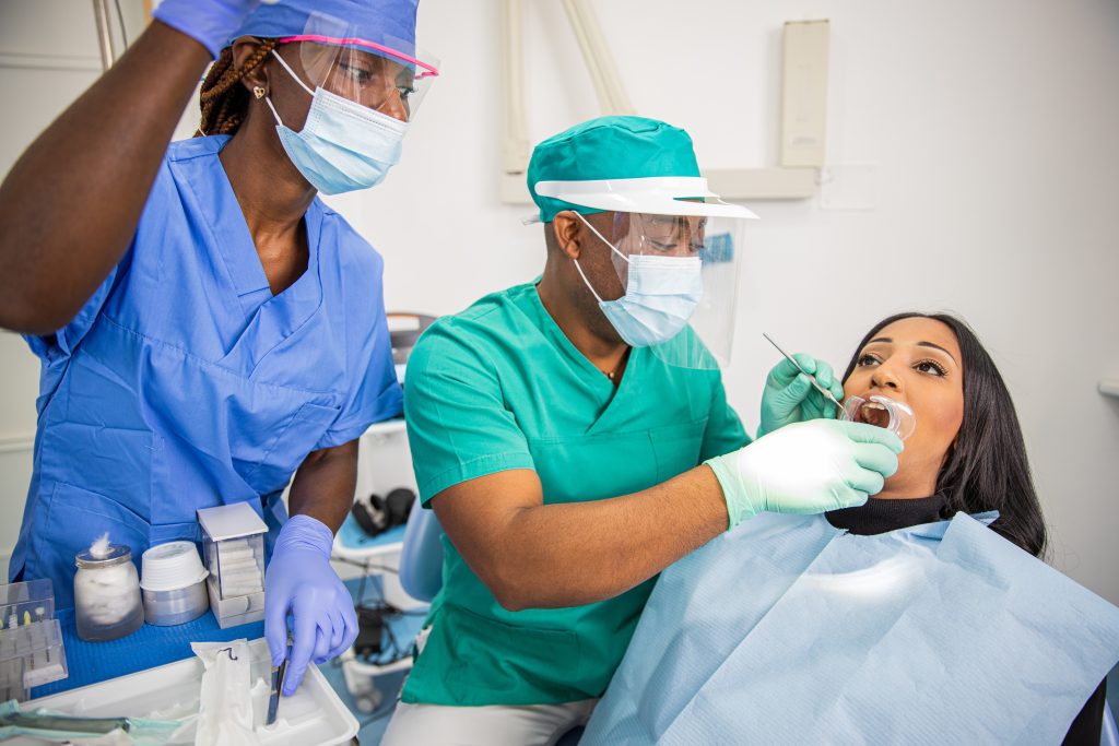 A dentist checks a patient's