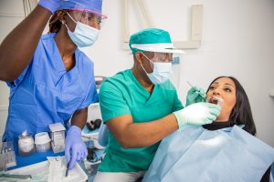 A dentist checks a patient's